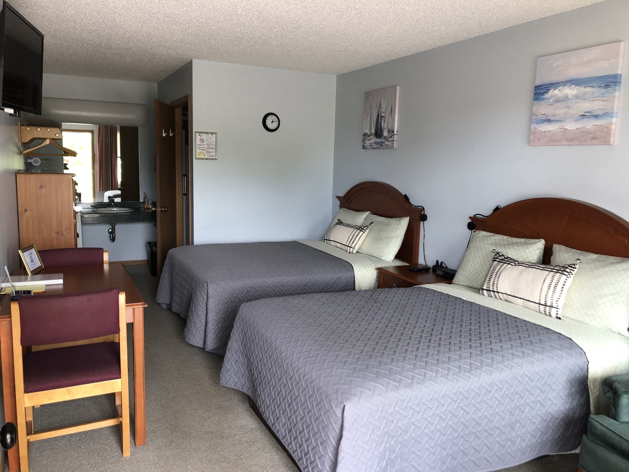 Double room with two beds, dining table, and vanity area