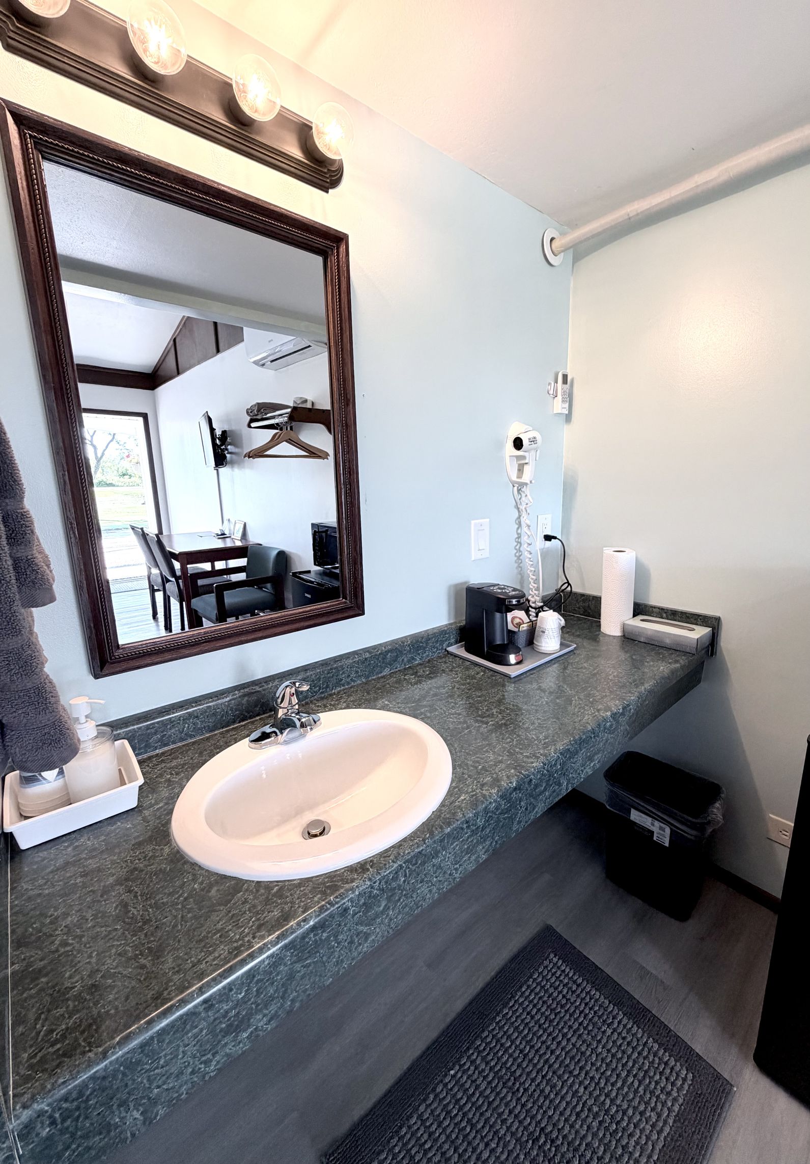 In-room vanity with sink, mirror, hair dryer, and coffee maker